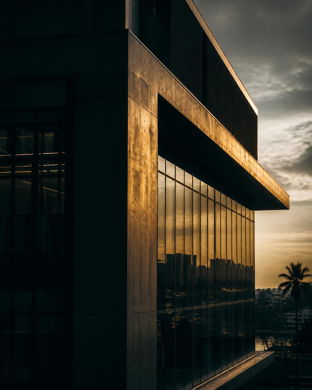 Modern office facade at dusk, Douala